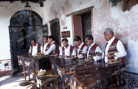 A traditional Music Band plays in a Restaurant in the old city in the town of Antigua in Guatemala in central America.   