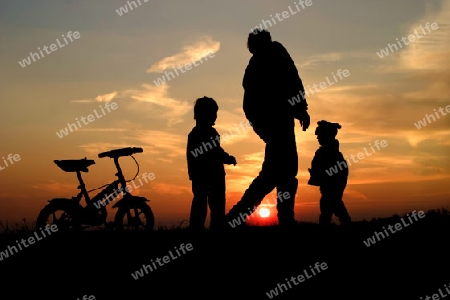 Mutter und die Kinder in der Sonnenuntergang