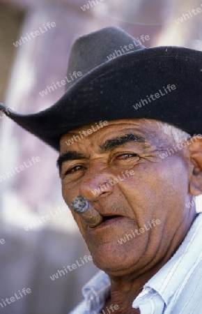 a signor with a cigar in the city of Santiago de Cuba on Cuba in the caribbean sea.