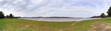 Beautiful high resolution panorama of a northern european country landscape with fields and green grass.