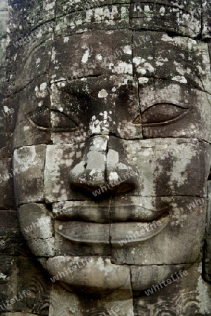 Stone Faces the Tempel Ruin of Angkor Thom in the Temple City of Angkor near the City of Siem Riep in the west of Cambodia.