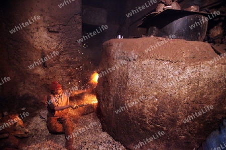 A men heat up Water for a Hammam or Arab Bath in the old City in the historical Town of Fes in Morocco in north Africa.