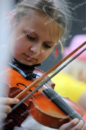 a Women in traditional dress on a Summer Festival in a Parc in the old City of Vilnius in the Baltic State of Lithuania,  