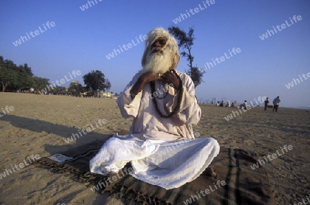 a Saddhu on the Chowpatty Beach in the city of Mumbai in India.