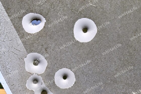 Detailed close up of bullet holes from gun shots in a german traffic sign