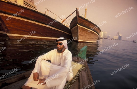 a city boat and ferry on the Dubai creek in the old town in the city of Dubai in the Arab Emirates in the Gulf of Arabia.