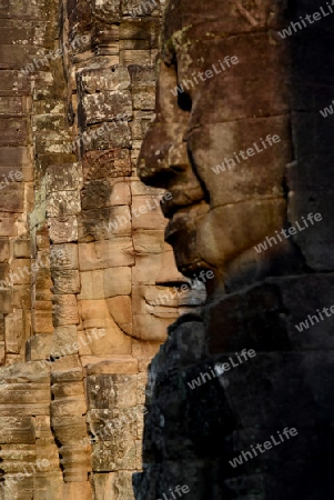 Stone Faces the Tempel Ruin of Angkor Thom in the Temple City of Angkor near the City of Siem Riep in the west of Cambodia.