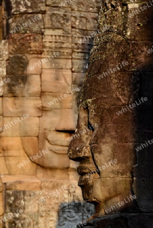 Stone Faces the Tempel Ruin of Angkor Thom in the Temple City of Angkor near the City of Siem Riep in the west of Cambodia.