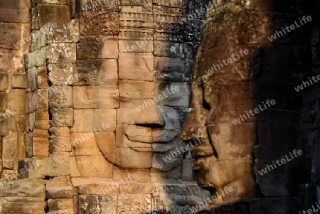 Stone Faces the Tempel Ruin of Angkor Thom in the Temple City of Angkor near the City of Siem Riep in the west of Cambodia.