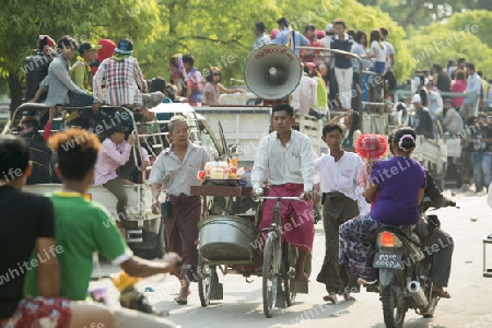 People at the Waterparty at the Thingyan Water Festival at the Myanmar New Year in the city centre of Mandalay in Manamar in Southeastasia.