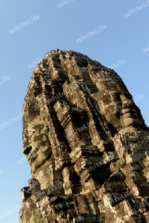 Stone Faces the Tempel Ruin of Angkor Thom in the Temple City of Angkor near the City of Siem Riep in the west of Cambodia.