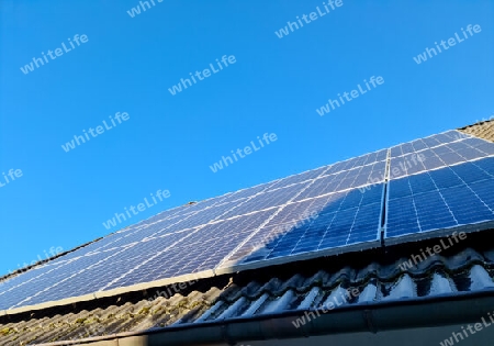 Solar panels producing clean energy on a roof of a residential house