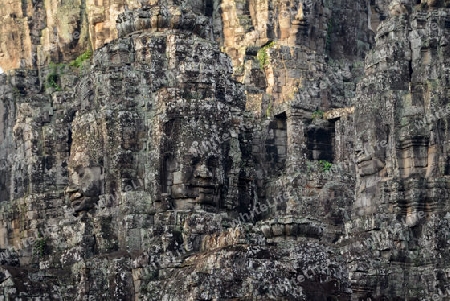 Stone Faces the Tempel Ruin of Angkor Thom in the Temple City of Angkor near the City of Siem Riep in the west of Cambodia.