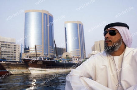 a city boat and ferry on the Dubai creek in the old town in the city of Dubai in the Arab Emirates in the Gulf of Arabia.