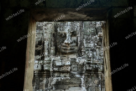 Stone Faces the Tempel Ruin of Angkor Thom in the Temple City of Angkor near the City of Siem Riep in the west of Cambodia.