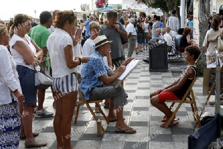 a Painter in the old Town of  Taormina in Sicily in south Italy in Europe.