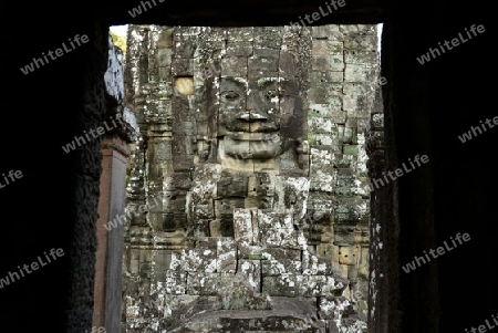 Stone Faces the Tempel Ruin of Angkor Thom in the Temple City of Angkor near the City of Siem Riep in the west of Cambodia.