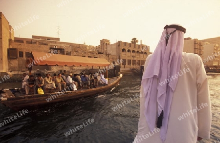 a city boat and ferry on the Dubai creek in the old town in the city of Dubai in the Arab Emirates in the Gulf of Arabia.