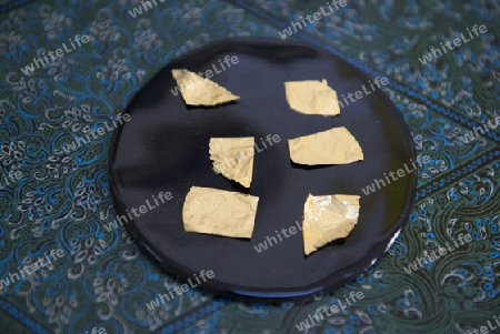 sheets of Gold leaf at a Gold pounder Factory the City of Mandalay in Myanmar in Southeastasia.