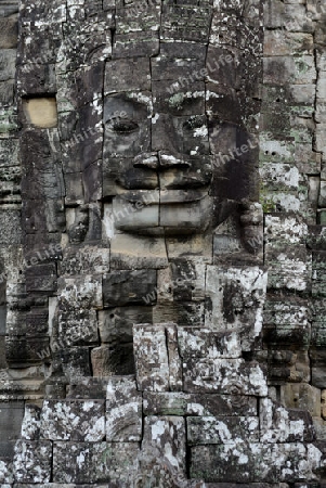 Stone Faces the Tempel Ruin of Angkor Thom in the Temple City of Angkor near the City of Siem Riep in the west of Cambodia.