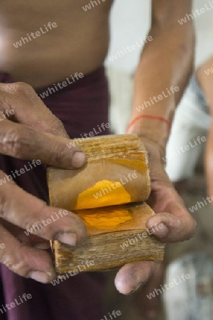 sheets of Gold leaf at a Gold pounder Factory the City of Mandalay in Myanmar in Southeastasia.