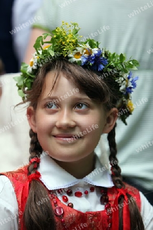 a Women in traditional dress on a Summer Festival in a Parc in the old City of Vilnius in the Baltic State of Lithuania,  