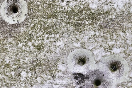 Detailed close up of bullet holes from gun shots in a german traffic sign