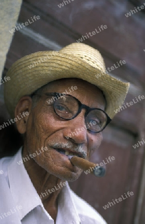 a signor with a cigar in the city of Santiago de Cuba on Cuba in the caribbean sea.