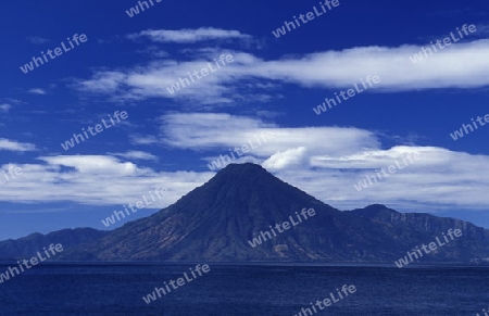 The Lake Atitlan mit the Volcanos of Toliman and San Pedro in the back at the Town of Panajachel in Guatemala in central America.   