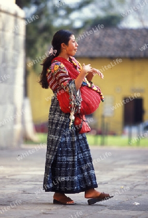  indio women in the old town in the city of Antigua in Guatemala in central America.   