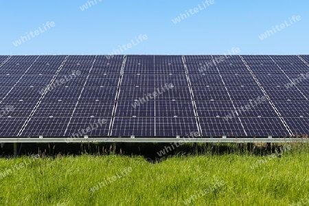 Generating clean energy with solar modules in a big park in northern Europe.