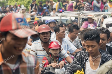 People at the Waterparty at the Thingyan Water Festival at the Myanmar New Year in the city centre of Mandalay in Manamar in Southeastasia.