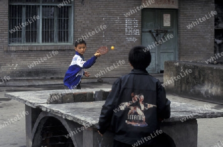 cilder play table tennis in the city of wushan on the yangzee river near the three gorges valley up of the three gorges dam project in the province of hubei in china.