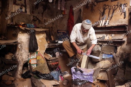 a shop in the Marketroad in the Medina of old City in the historical Town of Fes in Morocco in north Africa.