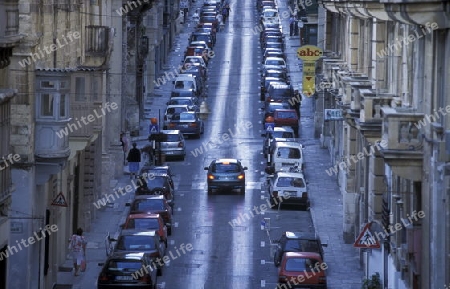 A smal road in the centre of the Old Town of the city of Valletta on the Island of Malta in the Mediterranean Sea in Europe.
