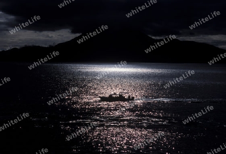 The Lake Atitlan mit the Volcanos of Toliman and San Pedro in the back at the Town of Panajachel in Guatemala in central America.   