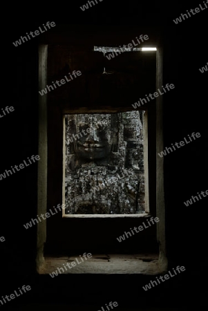 Stone Faces the Tempel Ruin of Angkor Thom in the Temple City of Angkor near the City of Siem Riep in the west of Cambodia.