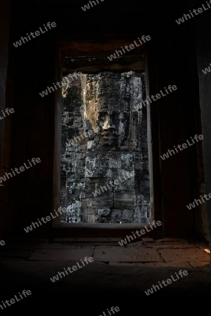 Stone Faces the Tempel Ruin of Angkor Thom in the Temple City of Angkor near the City of Siem Riep in the west of Cambodia.