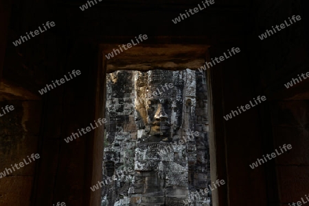 Stone Faces the Tempel Ruin of Angkor Thom in the Temple City of Angkor near the City of Siem Riep in the west of Cambodia.