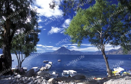 The Lake Atitlan mit the Volcanos of Toliman and San Pedro in the back at the Town of Panajachel in Guatemala in central America.   