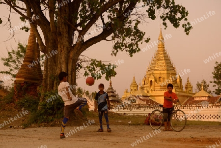 soccer player in soccer field in front of the Yadana Man Aung Pagoda in the town of Nyaungshwe at the Inle Lake in the Shan State in the east of Myanmar in Southeastasia.