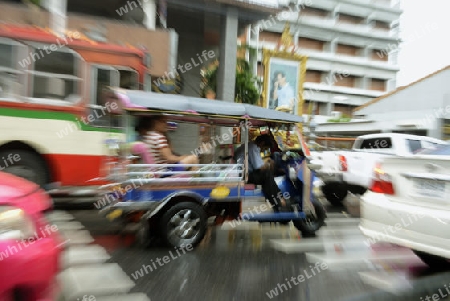 a tuck tuck by rain the Siam square aerea in the city of Bangkok in Thailand in Suedostasien.