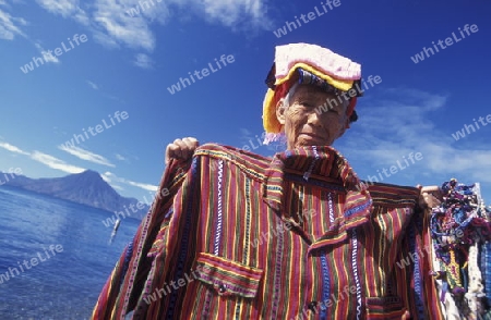 People at the coast of Lake Atitlan mit the Volcanos of Toliman and San Pedro in the back at the Town of Panajachel in Guatemala in central America.   