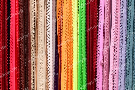 Detailed close up view on samples of cloth and fabrics in different colors found at a fabrics market.