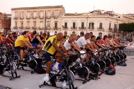 a fitness class in the old Town of Siracusa in Sicily in south Italy in Europe.