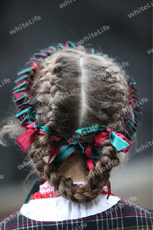 a Women in traditional dress on a Summer Festival in a Parc in the old City of Vilnius in the Baltic State of Lithuania,  