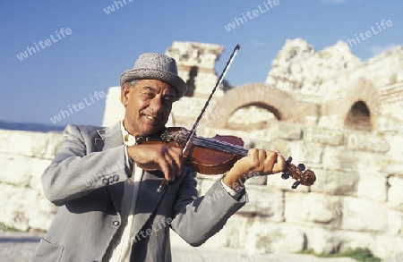 streetmusic in the ruin of the Basilica in the old town of  Nesebar on the coast of the Black sea in Bulgaria in east Europe.