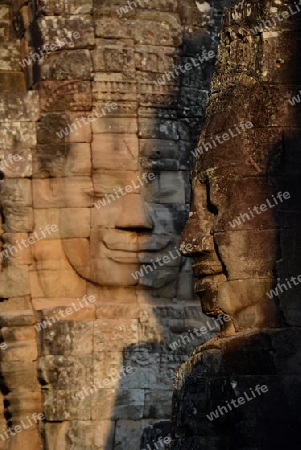 Stone Faces the Tempel Ruin of Angkor Thom in the Temple City of Angkor near the City of Siem Riep in the west of Cambodia.