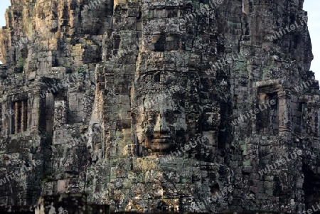 Stone Faces the Tempel Ruin of Angkor Thom in the Temple City of Angkor near the City of Siem Riep in the west of Cambodia.