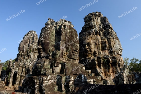 Stone Faces the Tempel Ruin of Angkor Thom in the Temple City of Angkor near the City of Siem Riep in the west of Cambodia.